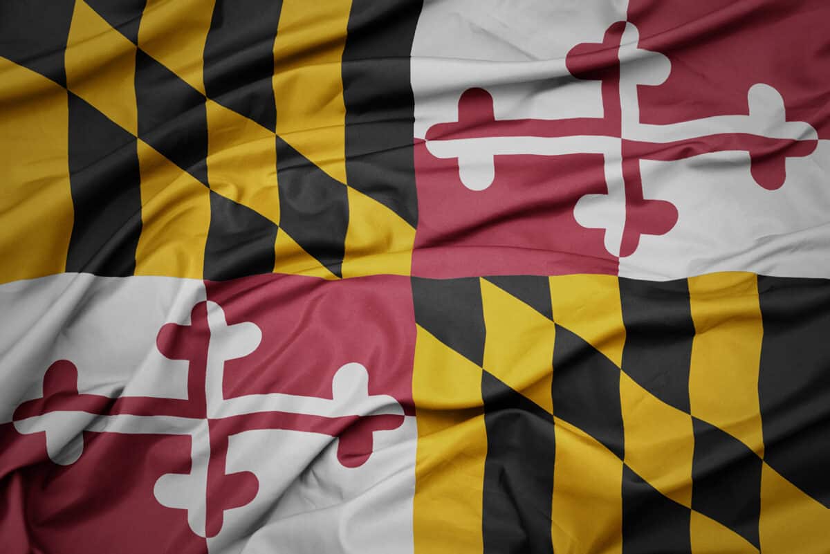 Close-up of a printed Maryland state flag, the Calvert and Crossland quarters in crisp color across the weave
