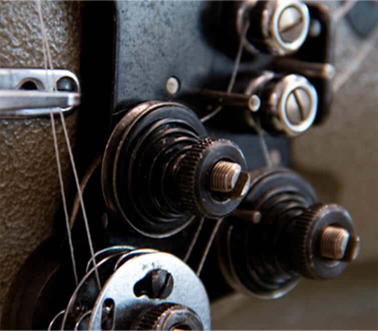 Close-up of a flagpole truck with pulleys and halyard lines used to raise a flag to half-staff