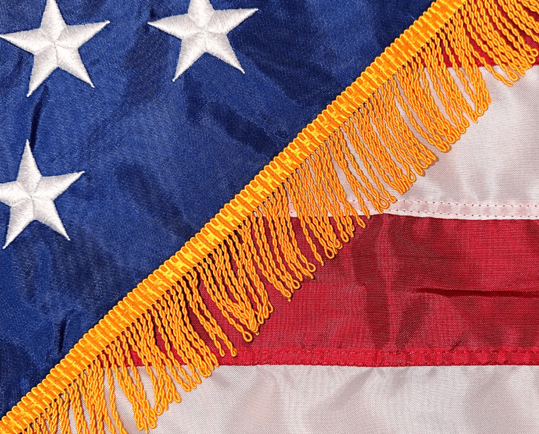 Close-up of gold fringe stitched along the edge of a U.S. flag