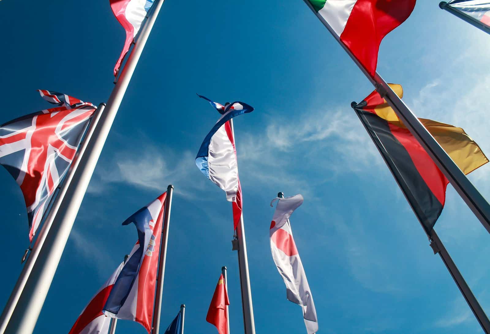 National flags of several countries flying on separate poles of equal height, the arrangement the US Flag Code calls for